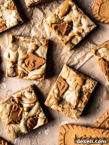 Cookie butter squares on brown parchment paper.