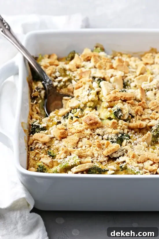 Non Dairy Broccoli Casserole in a baking dish with a spoon.