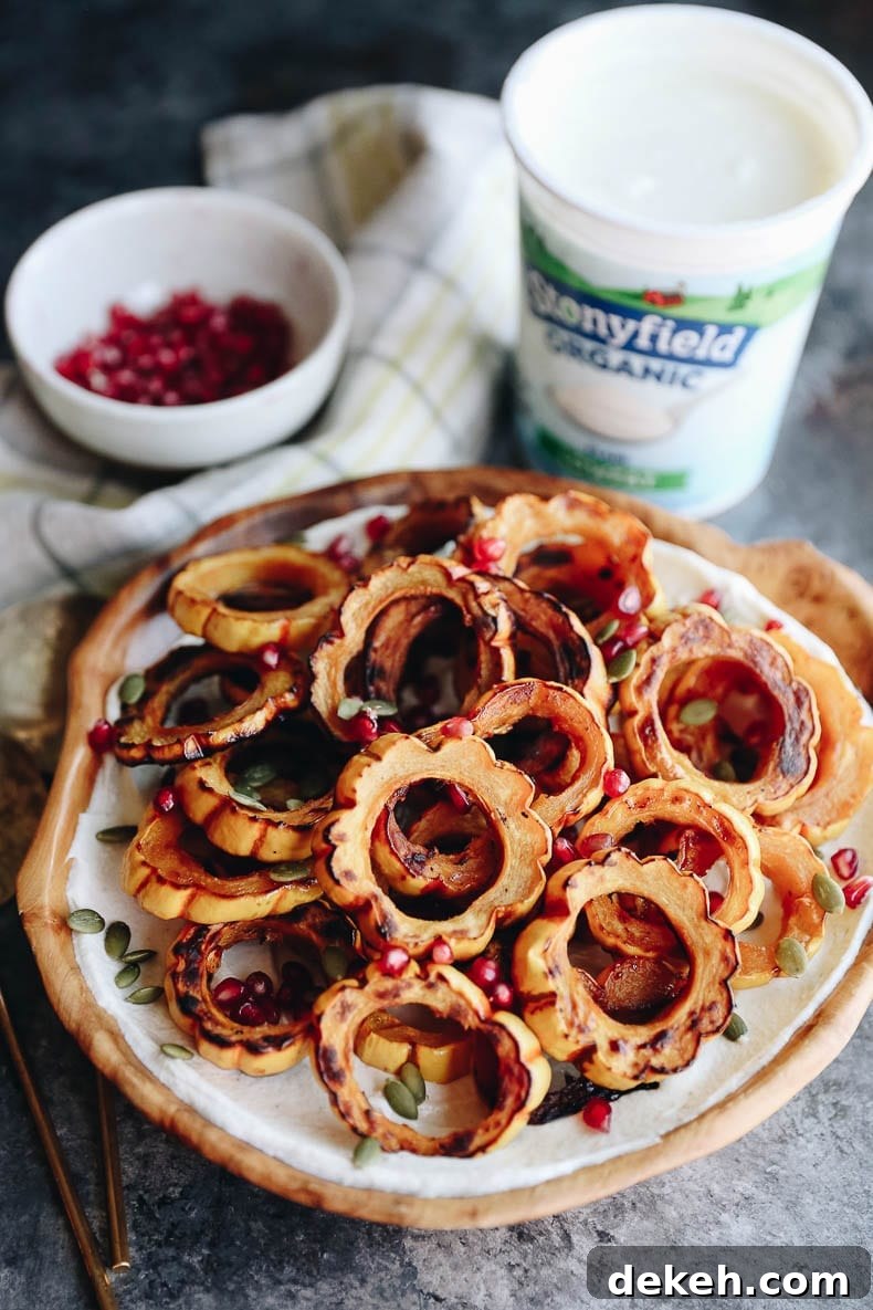 Maple roasted squash with tahini yogurt dressing topped with pepitas and pomegranate seeds