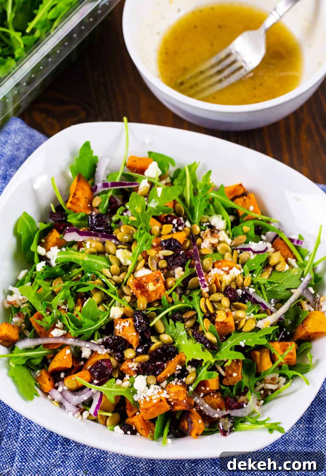 Sweet Potato Salad in a bowl and a bowl full of vinaigrette.