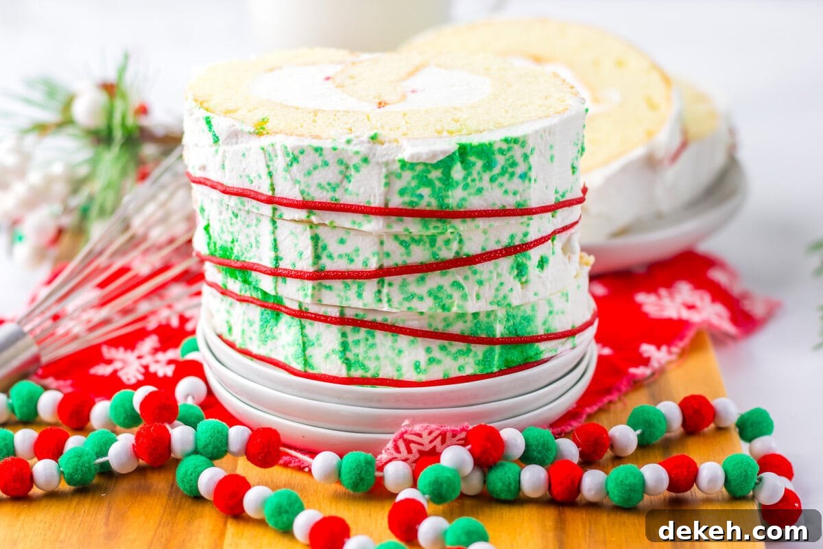 An image of a slice of Christmas roll cake on a serving plate.