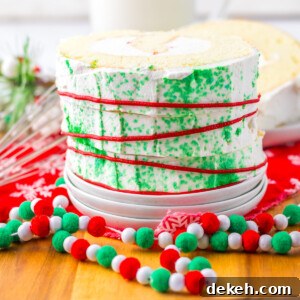 A close up image of a slice of Christmas cake roll.