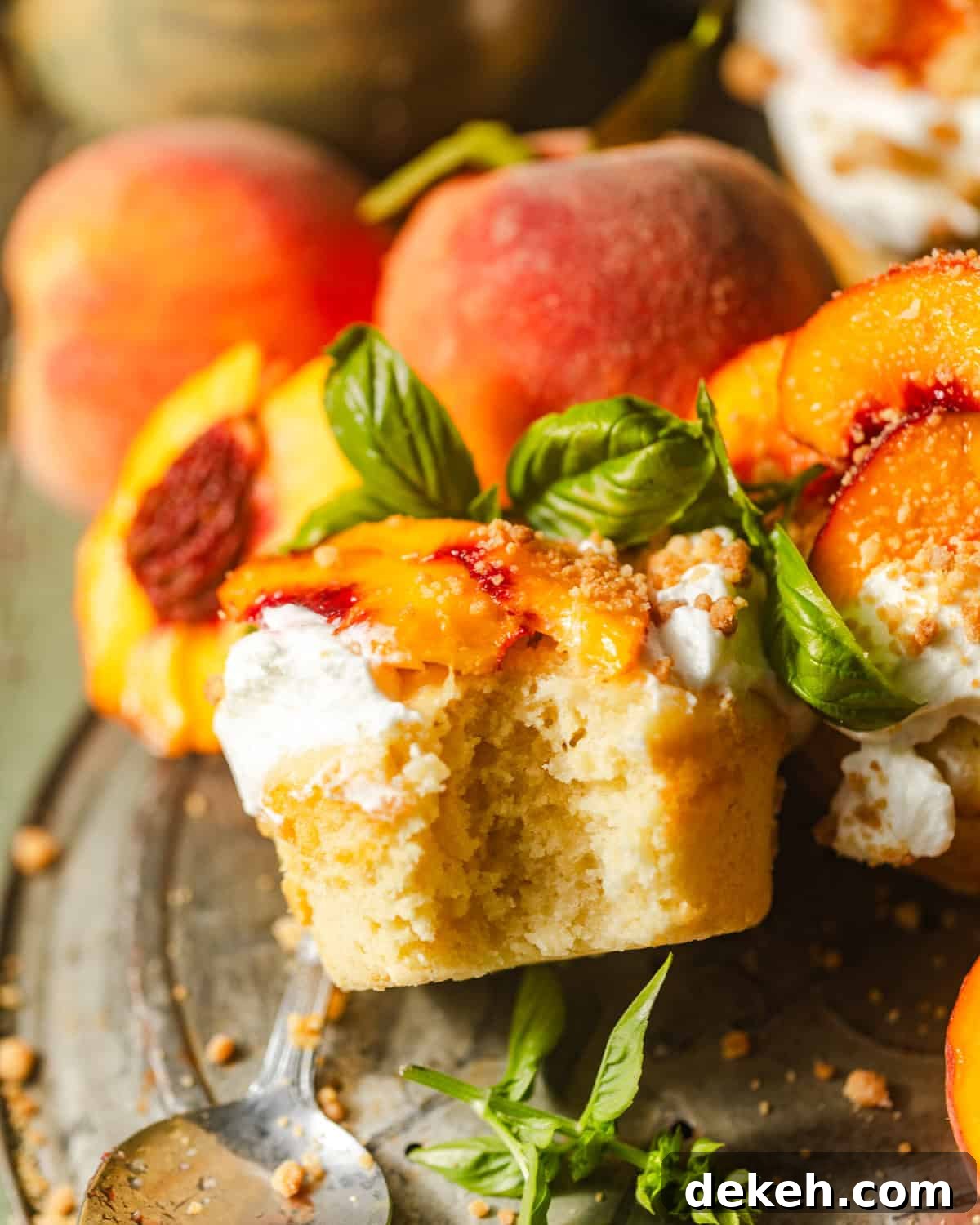 a peach shortcake on a pie plate with a bite taken out of the cake so that you can see the inside.