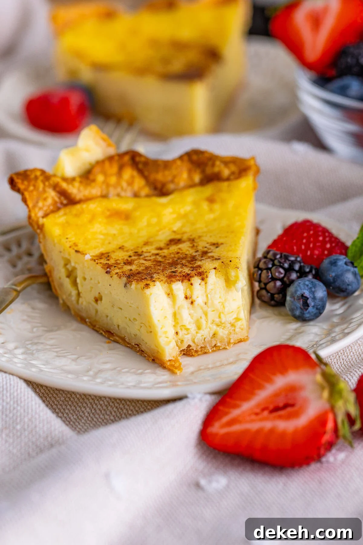 Pie on plate with bite taken out of it.