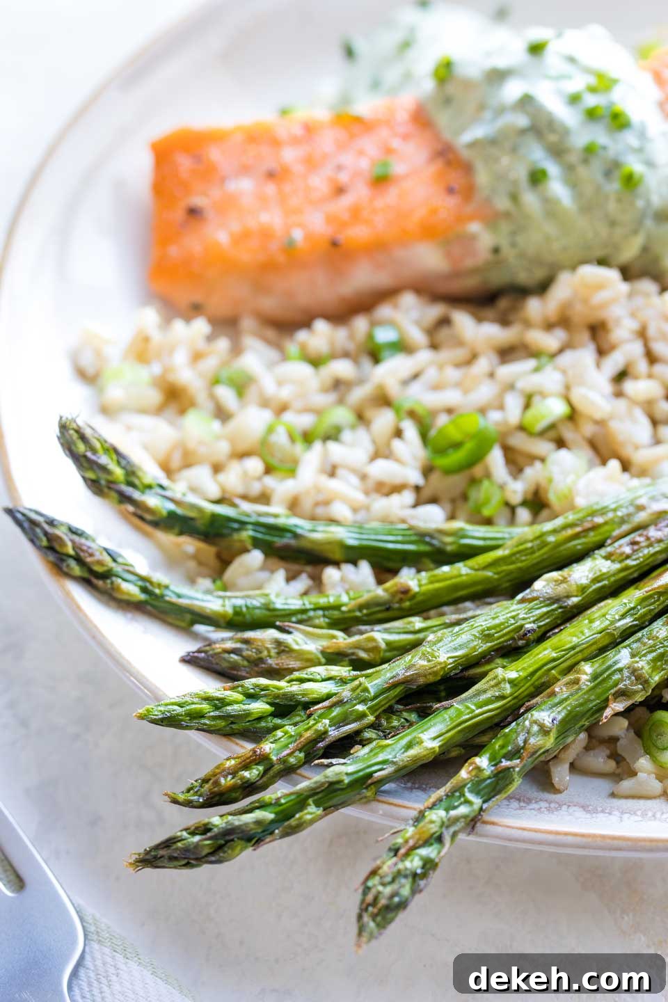 A serving suggestion for this recipe as a side dish, plated on a bed of rice alongside a salmon filet.