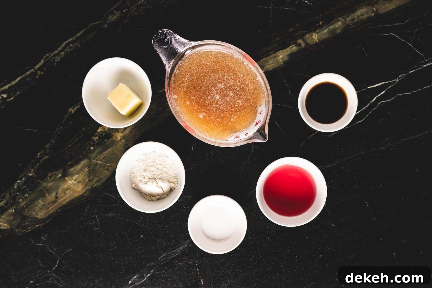 Sauce ingredients in white bowls on table.