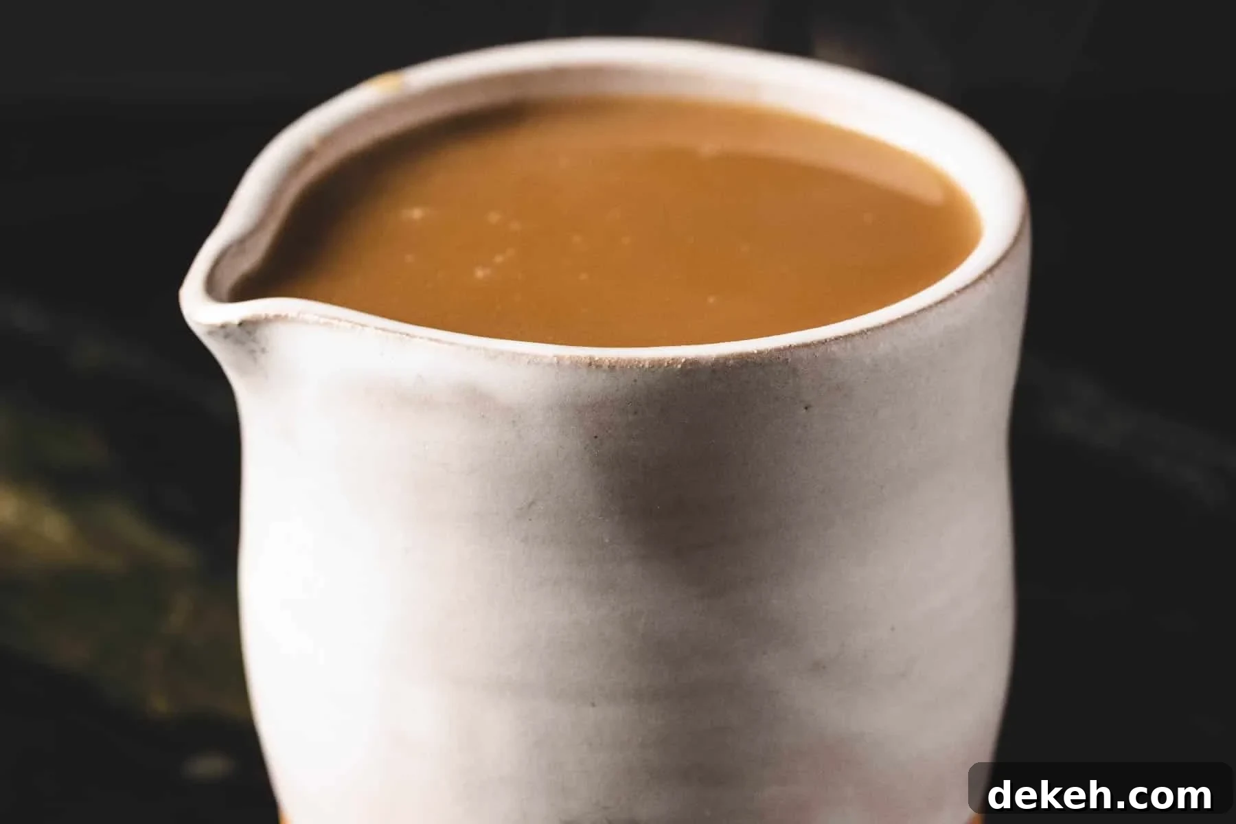 Gravy in white serving cup.