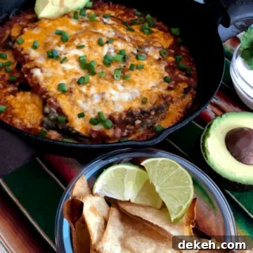 baked chile rellenos in a cast iron pan with chips, sour cream and avocado