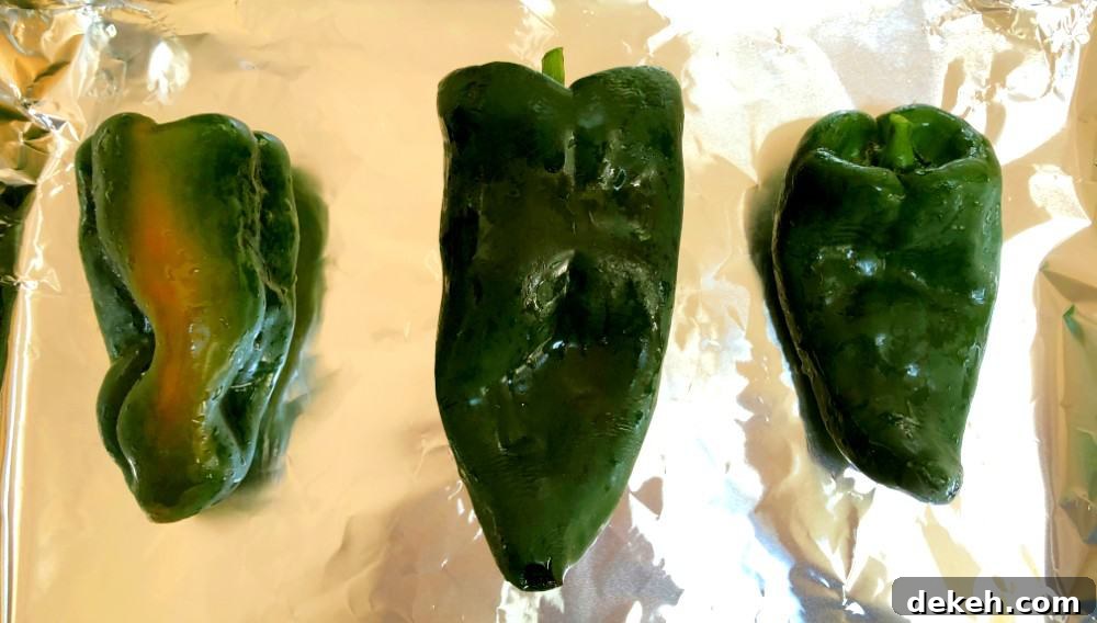 poblano pepper on a baking sheet with tin foil for roasting.