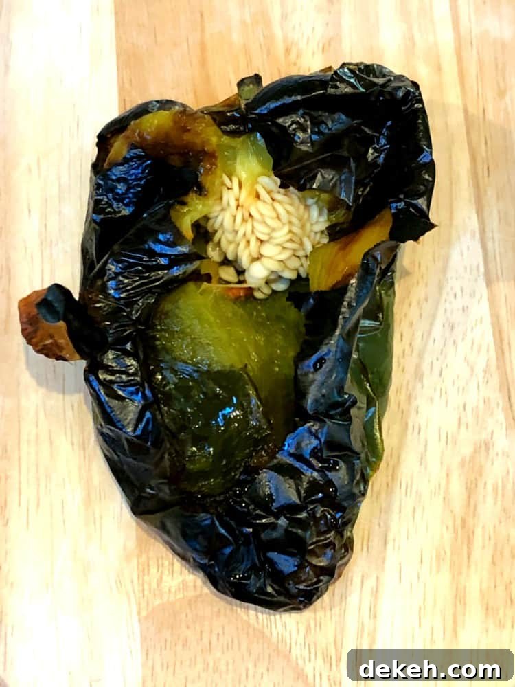 roasted poblano pepper cut open to show seeds.