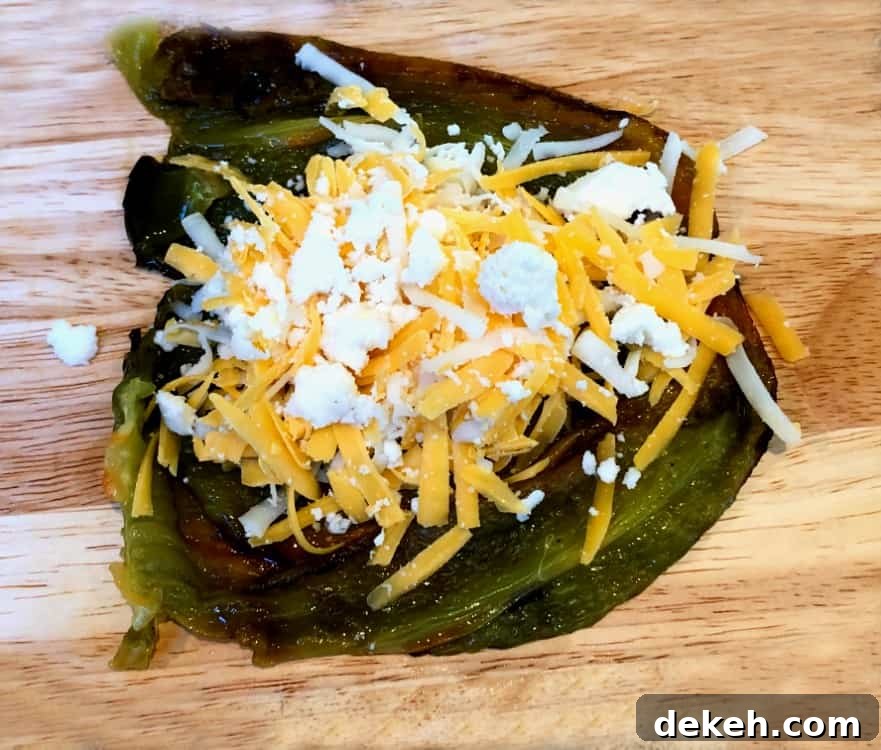 roasted poblano pepper cut open and stuffed with cheese.