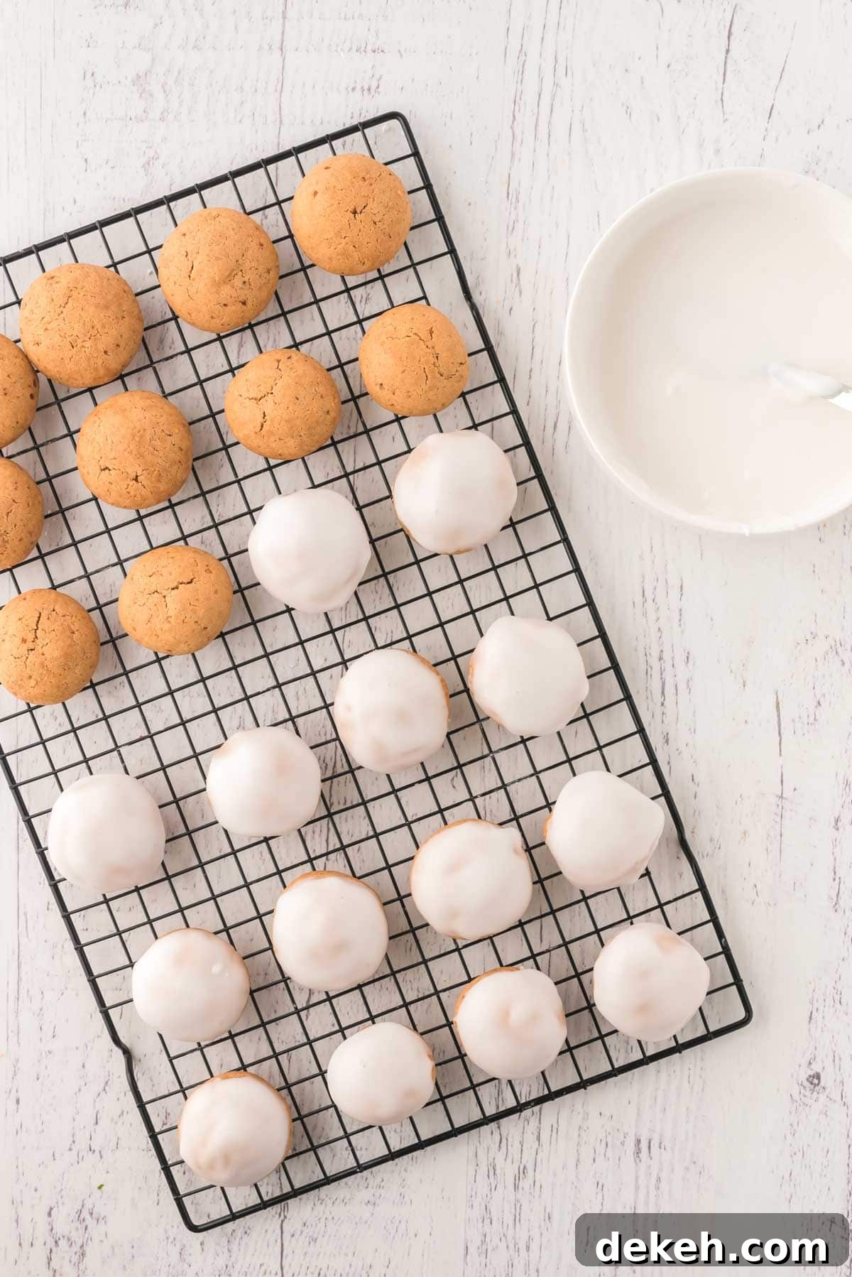 Pfeffernüsse on a wire cooling rack, some with glaze and some without.