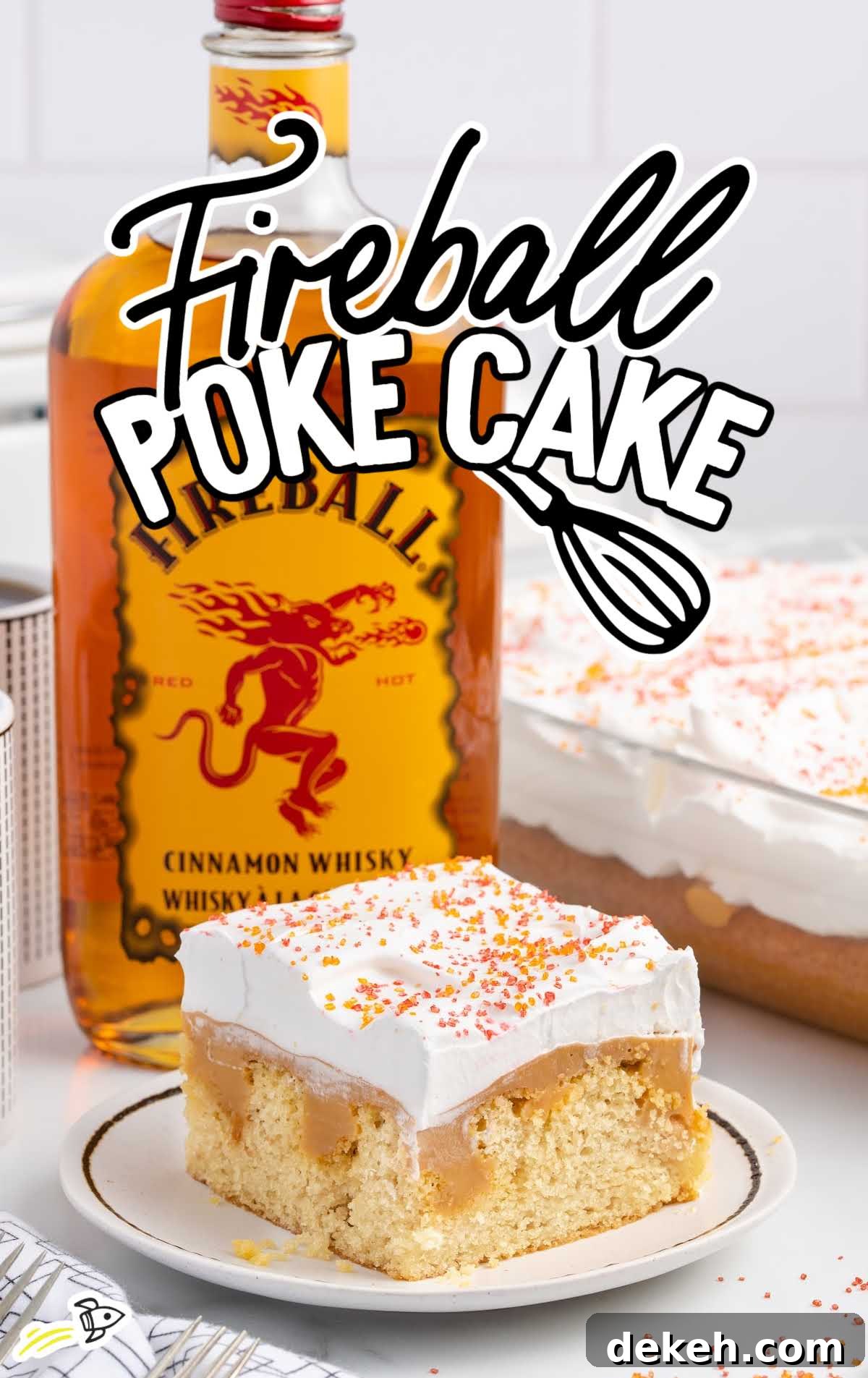close up shot of a cake on a plate with a fireball bottle in the background