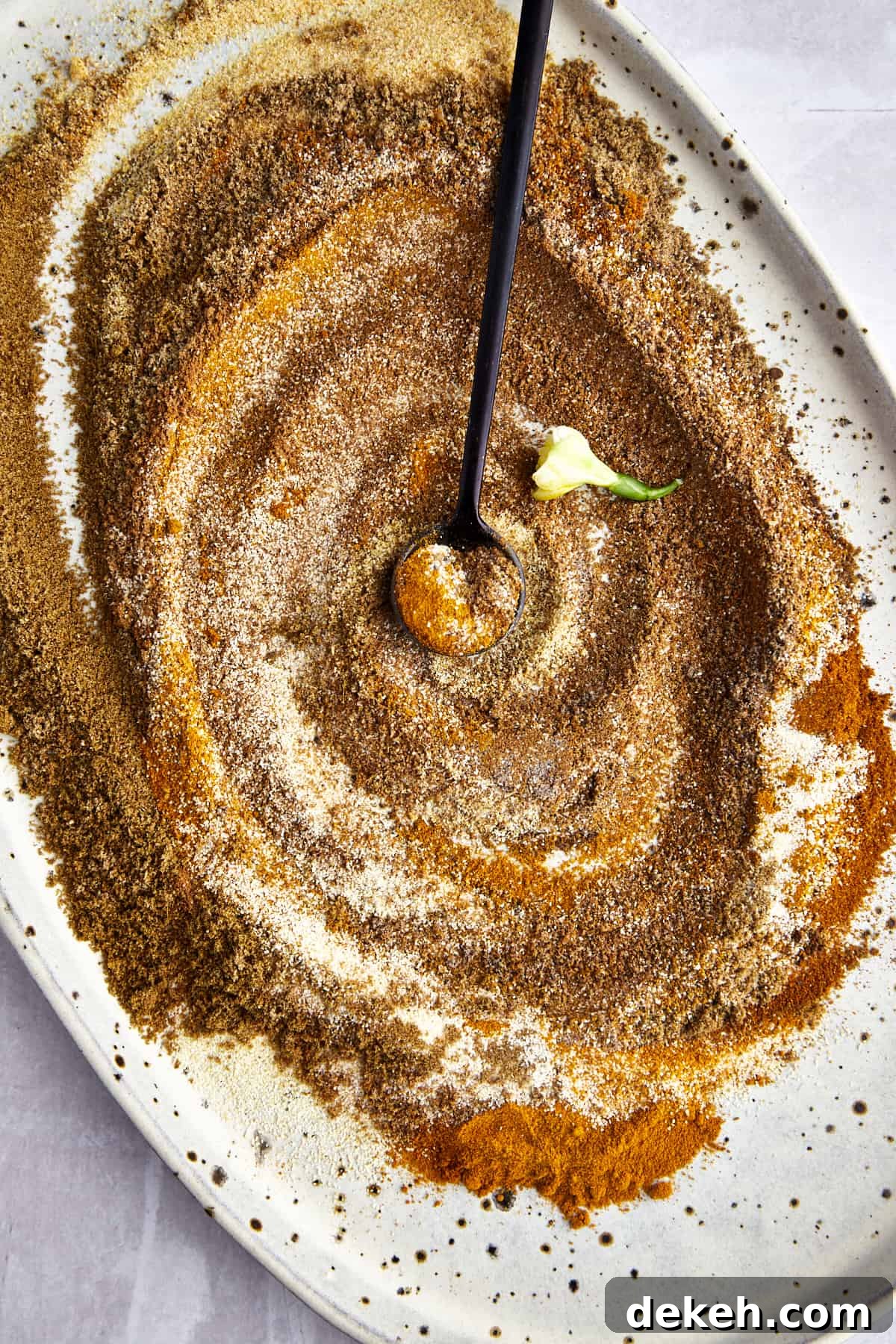 Shawarma spices being mixed together to make a DIY shawarma seasoning blend. 
