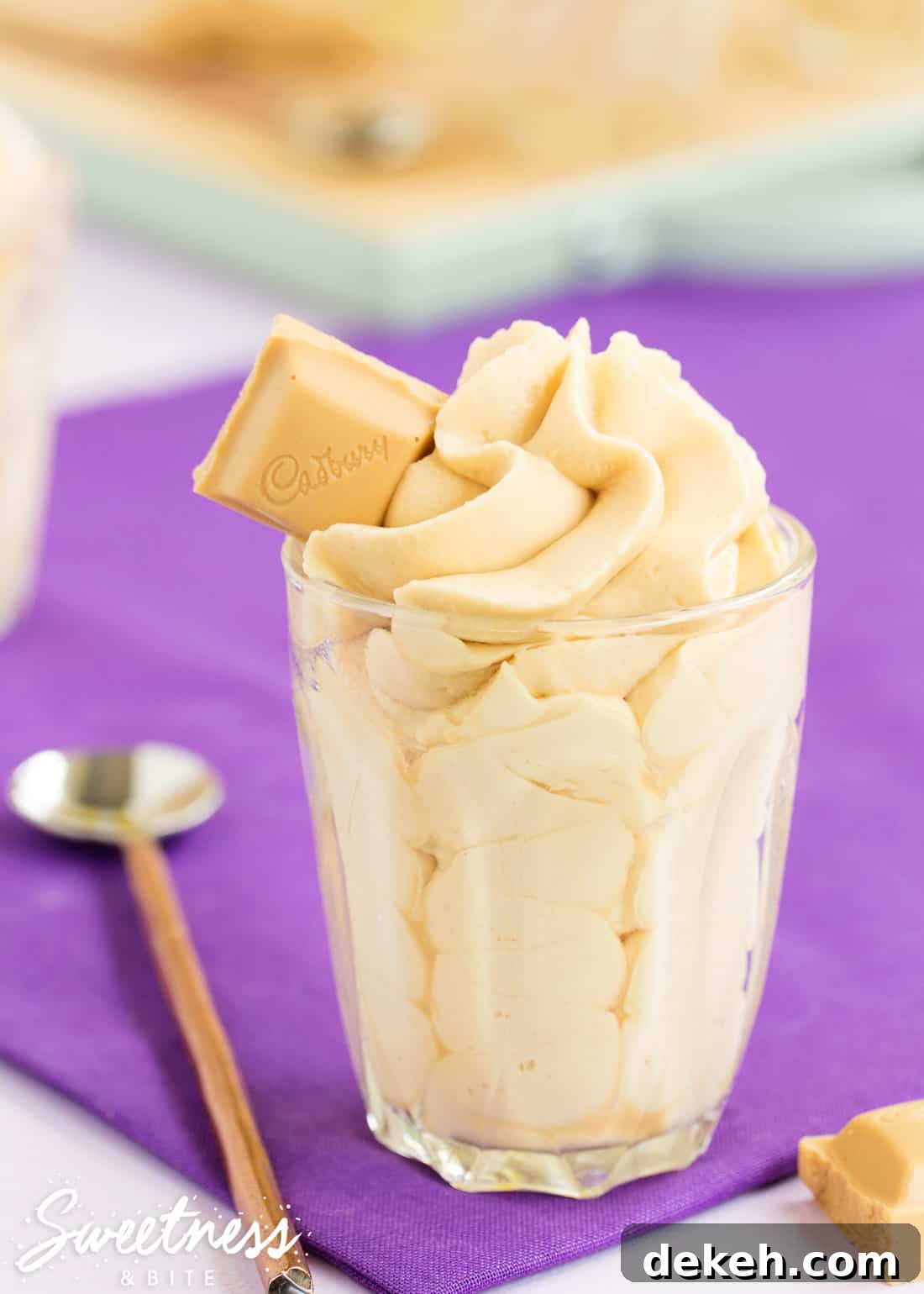 Caramilk Mousse, piped in a swirl into a small glass with a square of Caramilk chocolate on top.