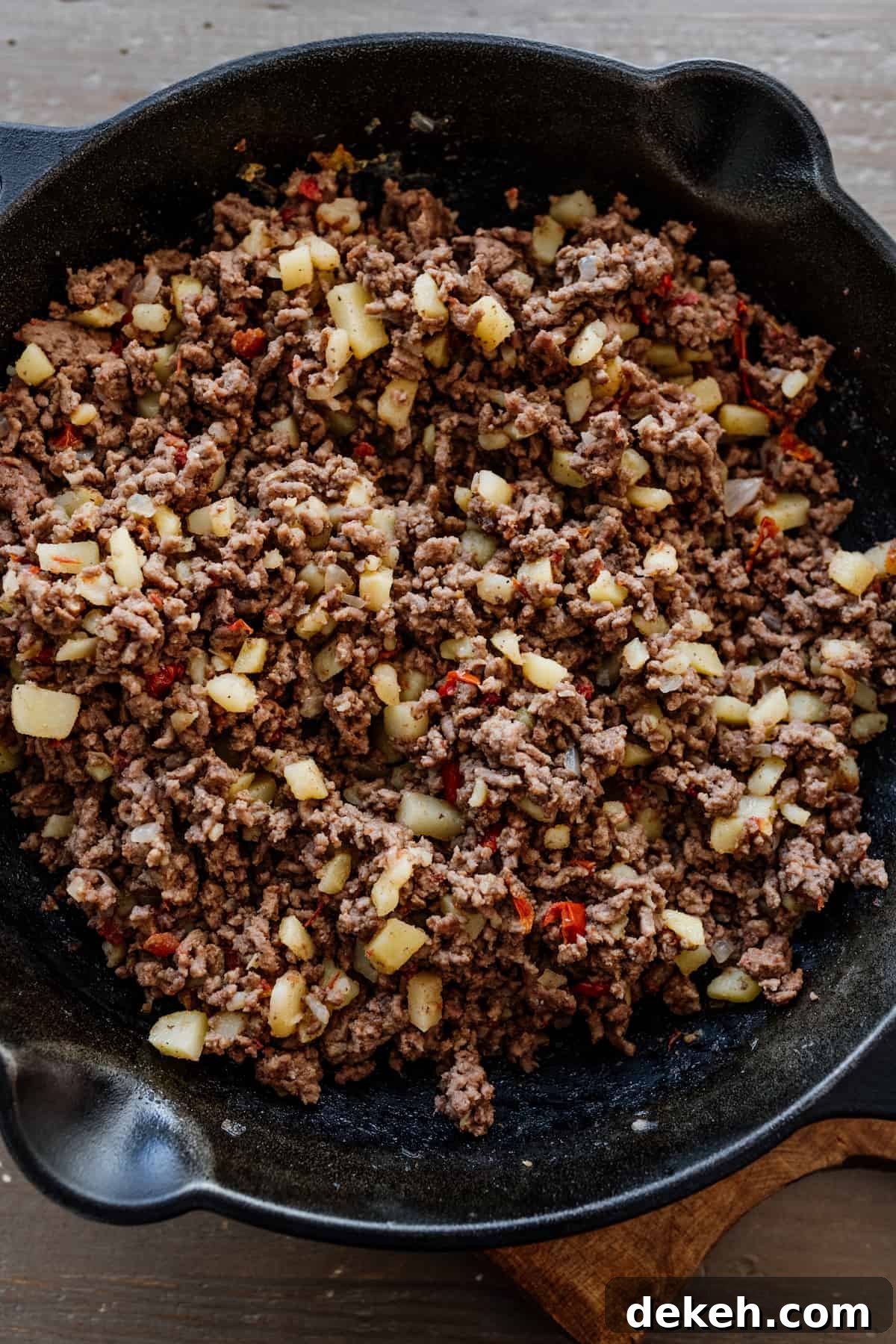 Mexican ground beef picadillo in a cast iron skillet.
