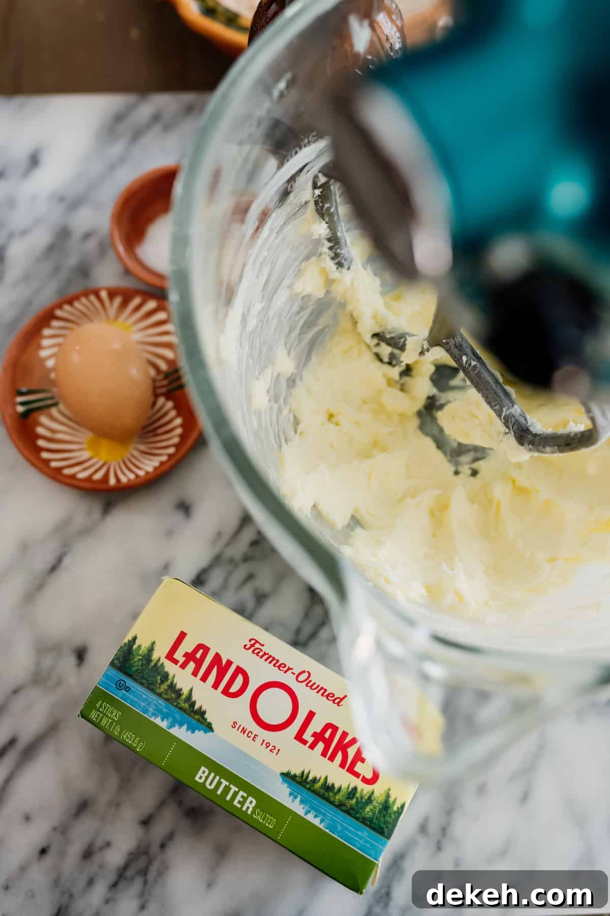 whipping butter in a stand mixer for making homemade empanada dough.