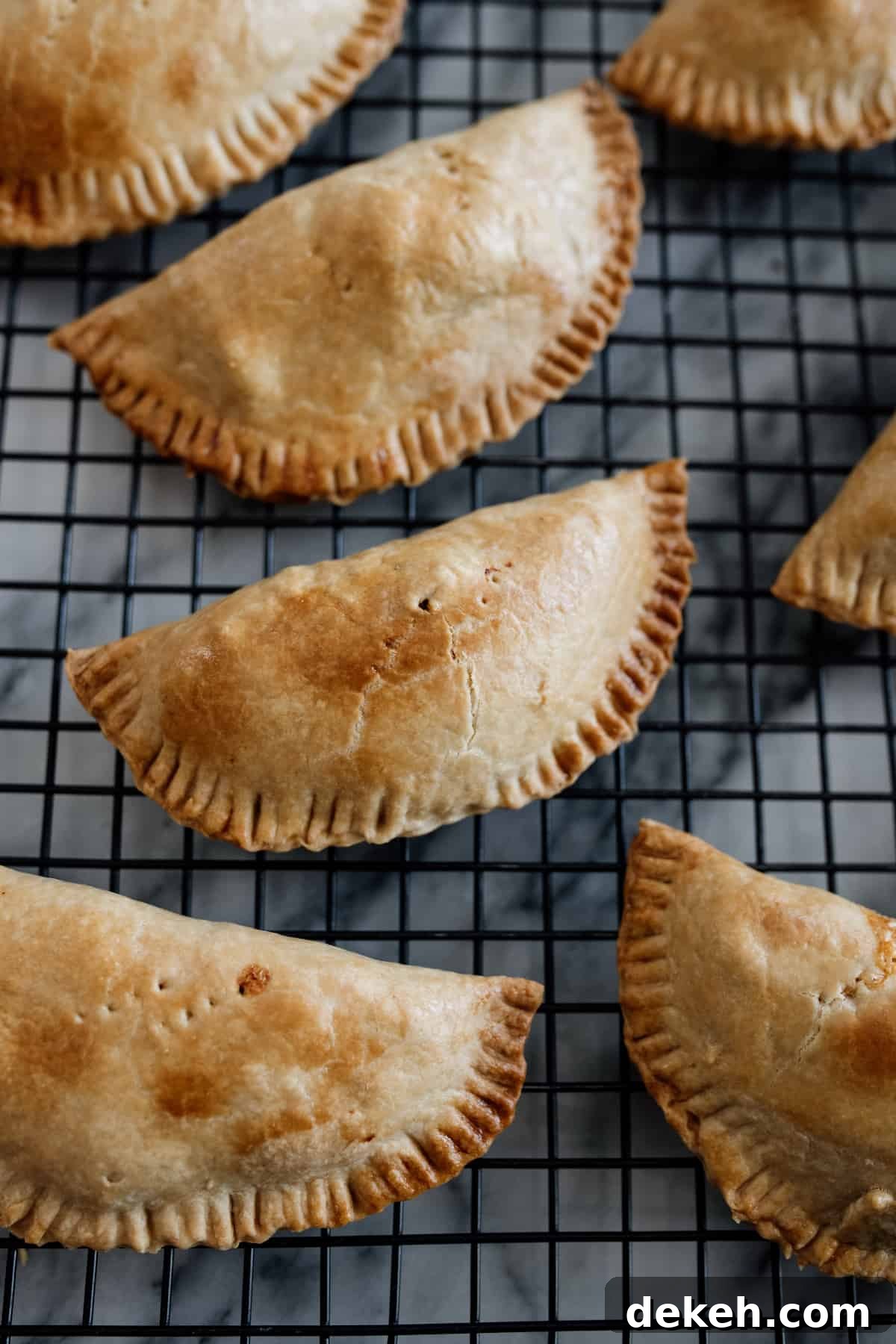 baked empanadas on a cooling rack.