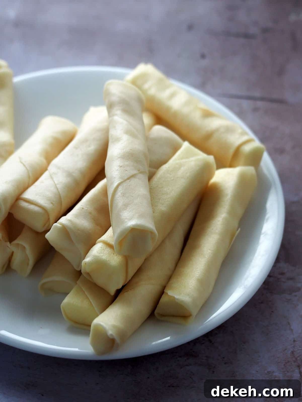 spring rolls filled with cheese on a white plate