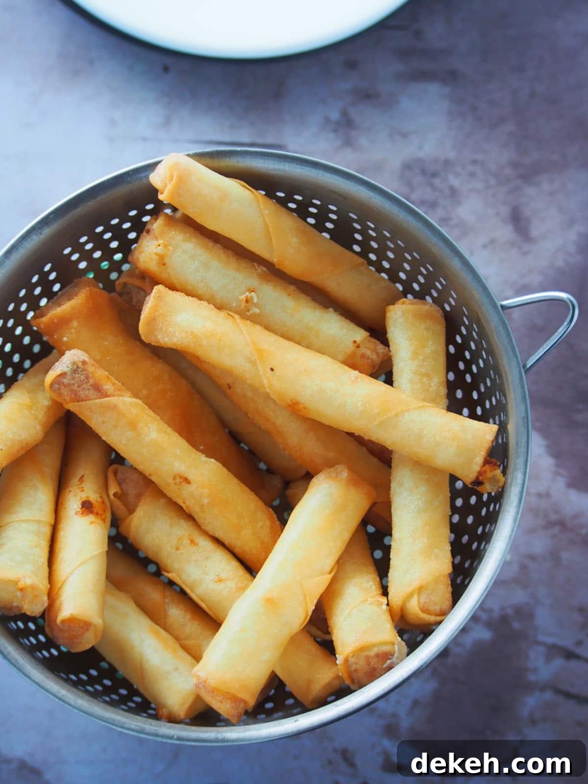 fried cheese sticks on a metal colander