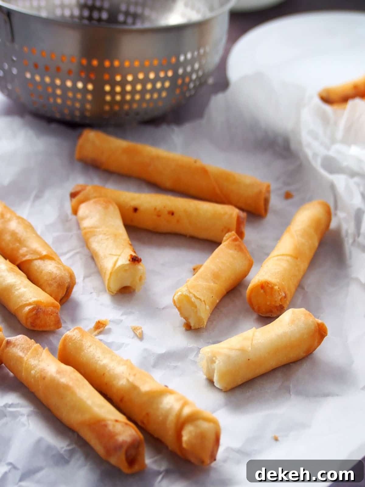 cheesy spring rolls on parchment paper