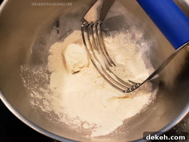 Using a pastry blender to cut shortening into flour