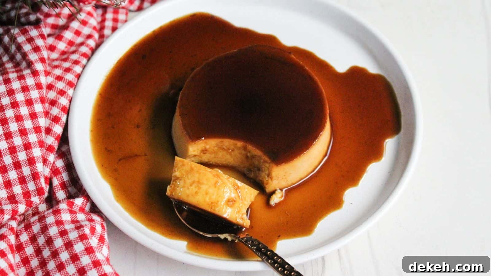Leche flan caramel creme brulee on a plate with a spoon.