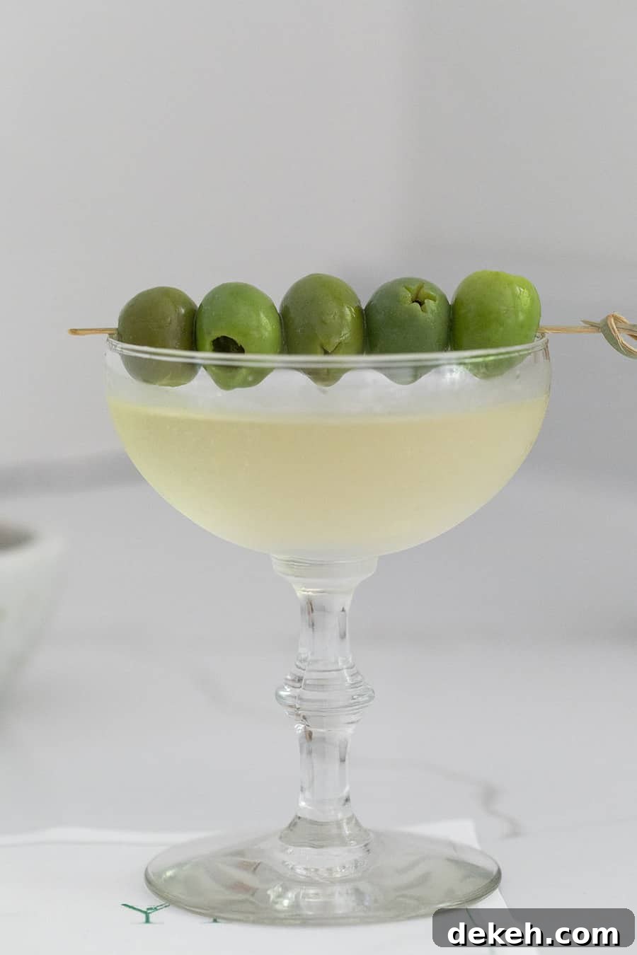 Easy dirty martini recipe with extra olives.