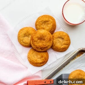 A plate of freshly-baked homemade snickerdoodles transferred from the cookie sheet with a spatula.