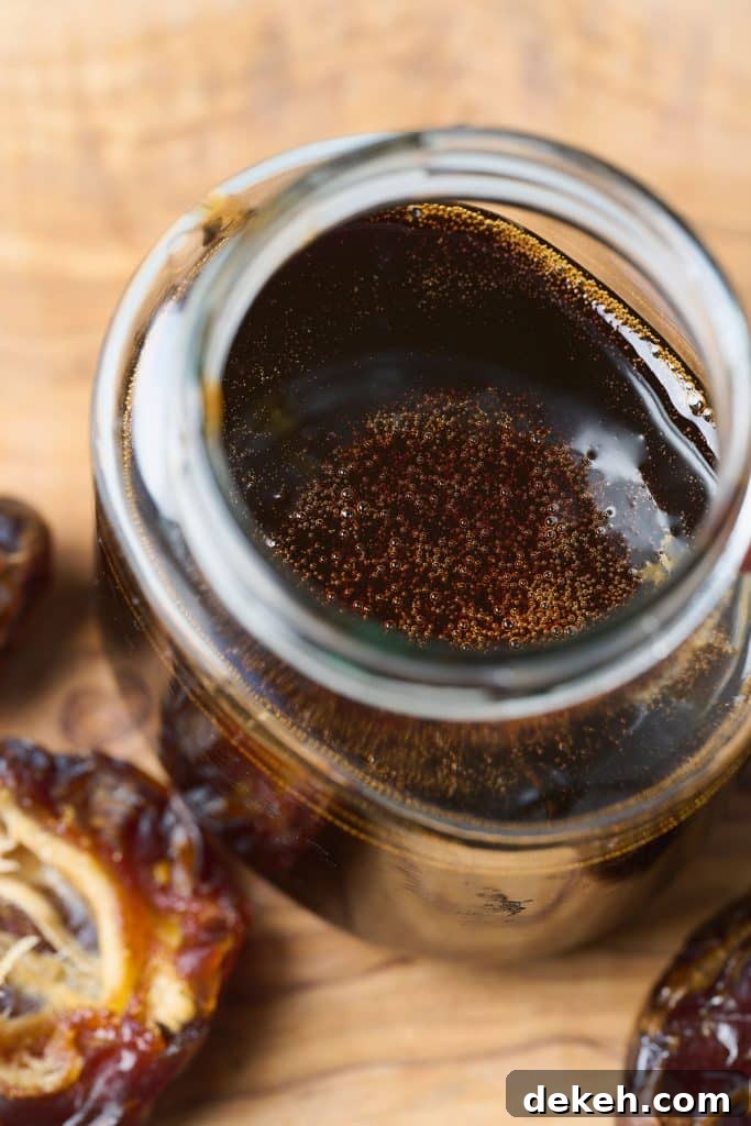 Close up view of a jar of homemade date syrup 