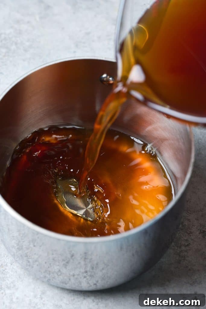 Squeezed date mixture from cheesecloth being brought to a boil in a saucepan 