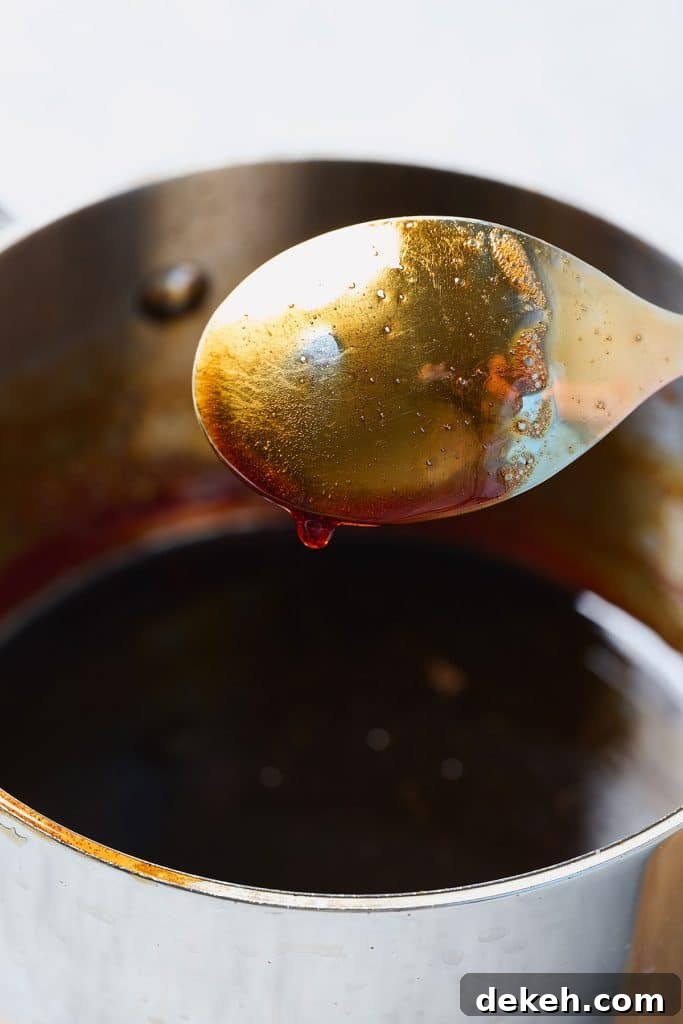 Rich and thick date syrup coating a spoon