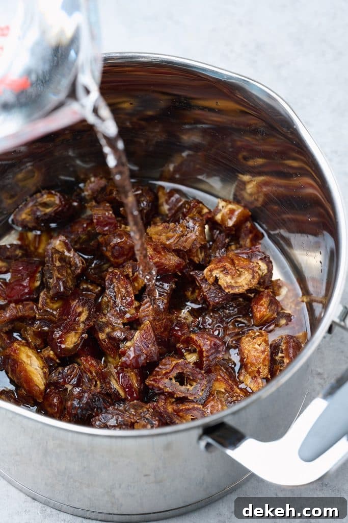 water being poured into pot with dates to be brought to a boil