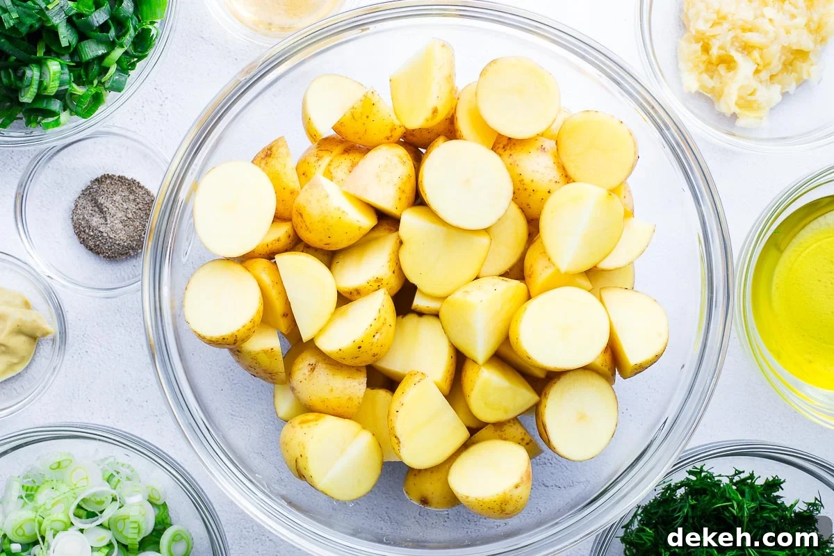 Prepared ingredients for a no-mayo, no-egg potato salad viewed from above, arranged in bowls.