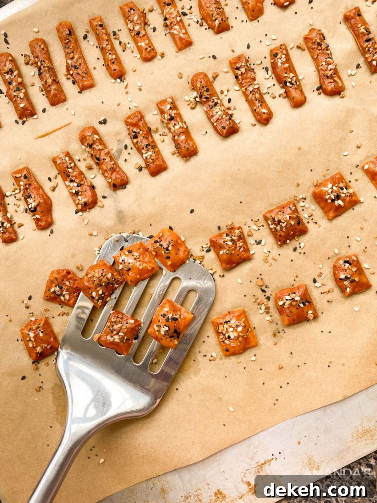 spatula lifting keto cheese crackers from baking sheet