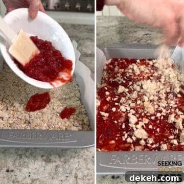 Adding the jam to the pan for strawberry oatmeal bars, and then topping with more oat mixture.