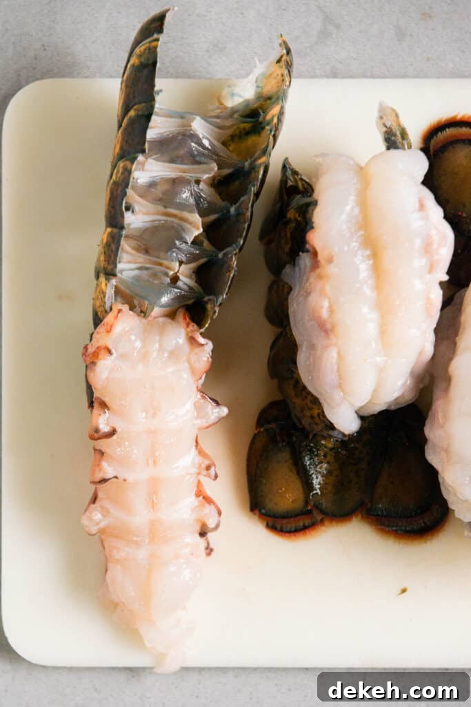 pulling lobster tail meat from shell