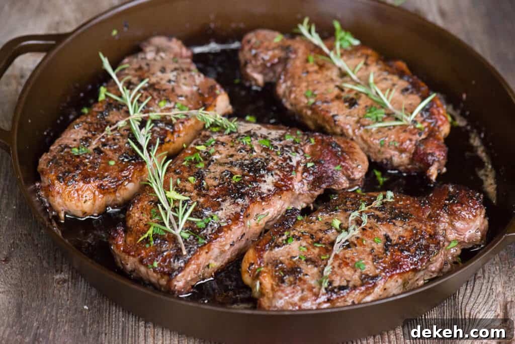 New York Strip Steaks in cast iron pan