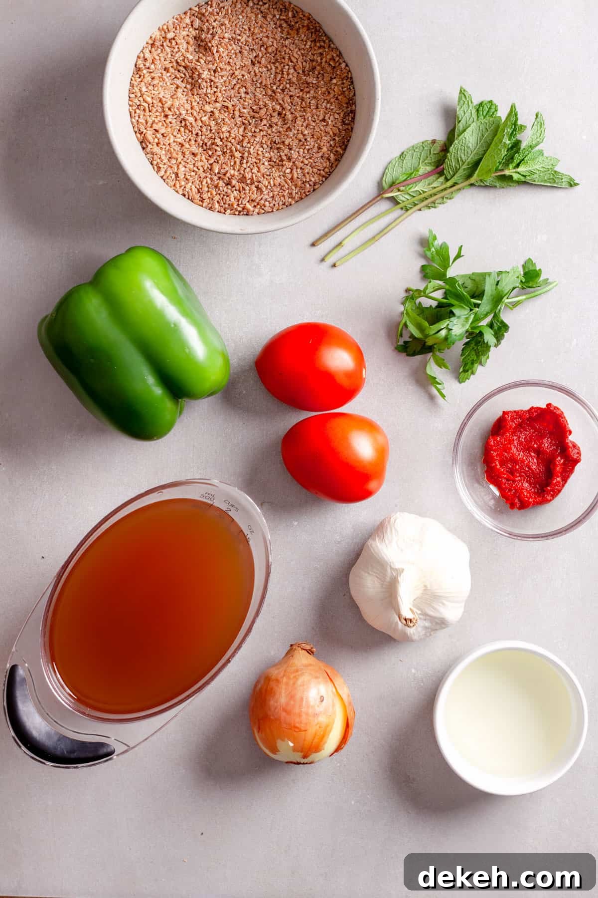 Ingredients for bulgur pilaf on a gray table.
