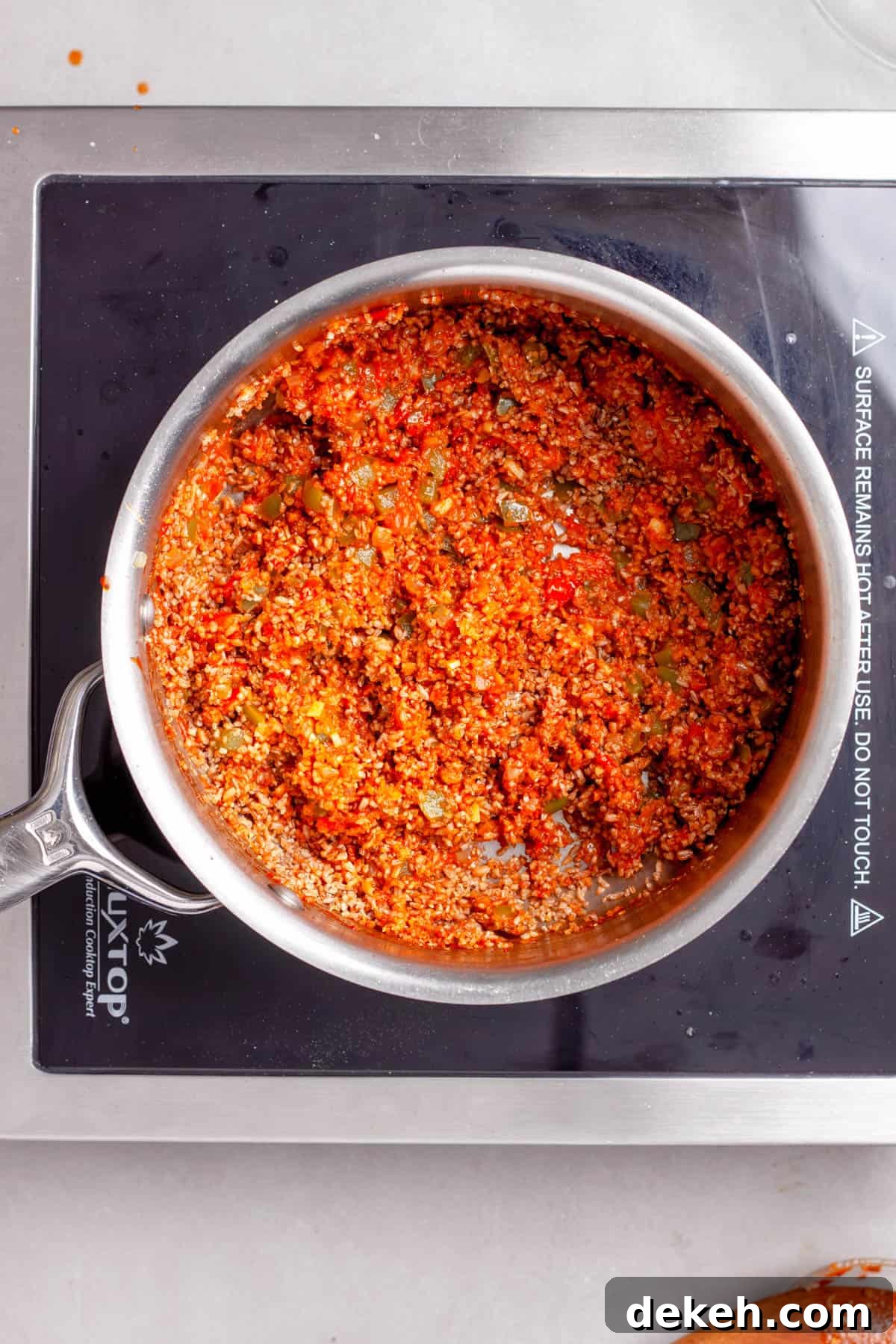 Bulgur added to a saucepan with aromatics for a bulgur pilaf.
