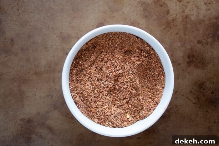 keto taco seasoning in a white bowl on a distressed serving tray