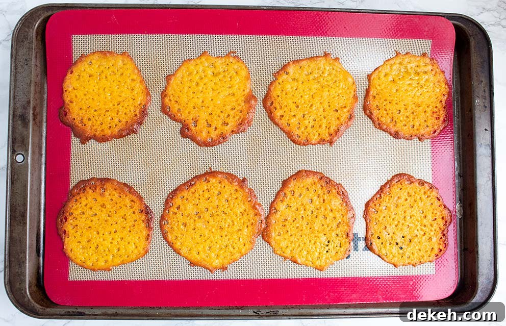 cooked keto taco cups on a silicone baking mat