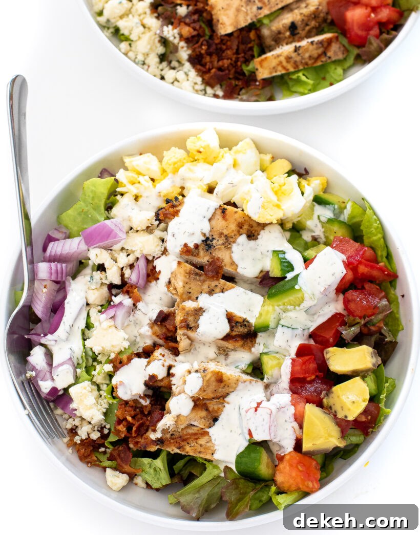 Overhead shot of chicken cobb salad with homemade ranch in a bowl. 