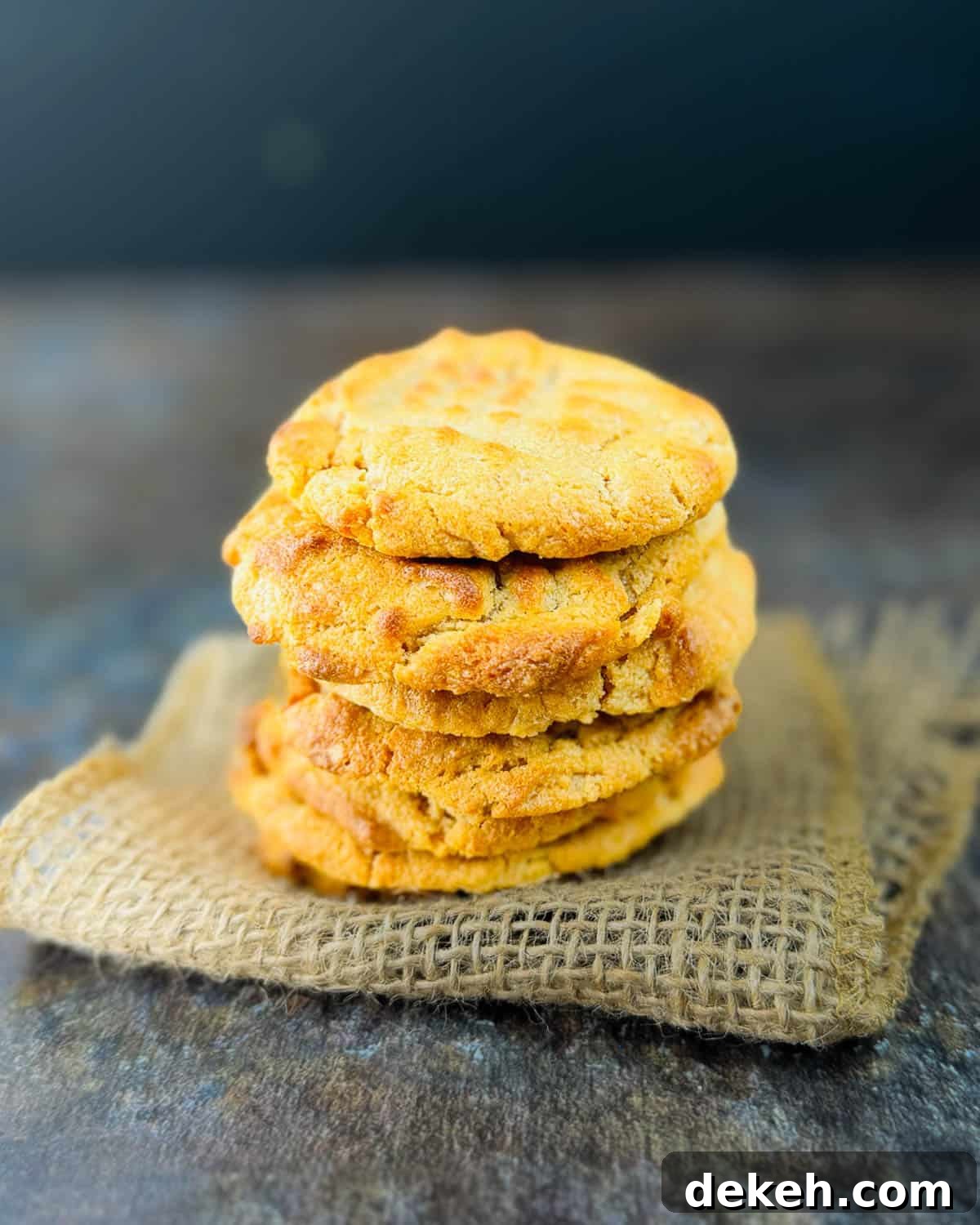 Stack of peanut butter cookies showing classic criss-cross pattern with soft, chewy centers and crispy edges.