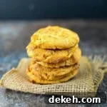 Stack of peanut butter cookies showing classic criss-cross pattern with soft, chewy centers and crispy edges.