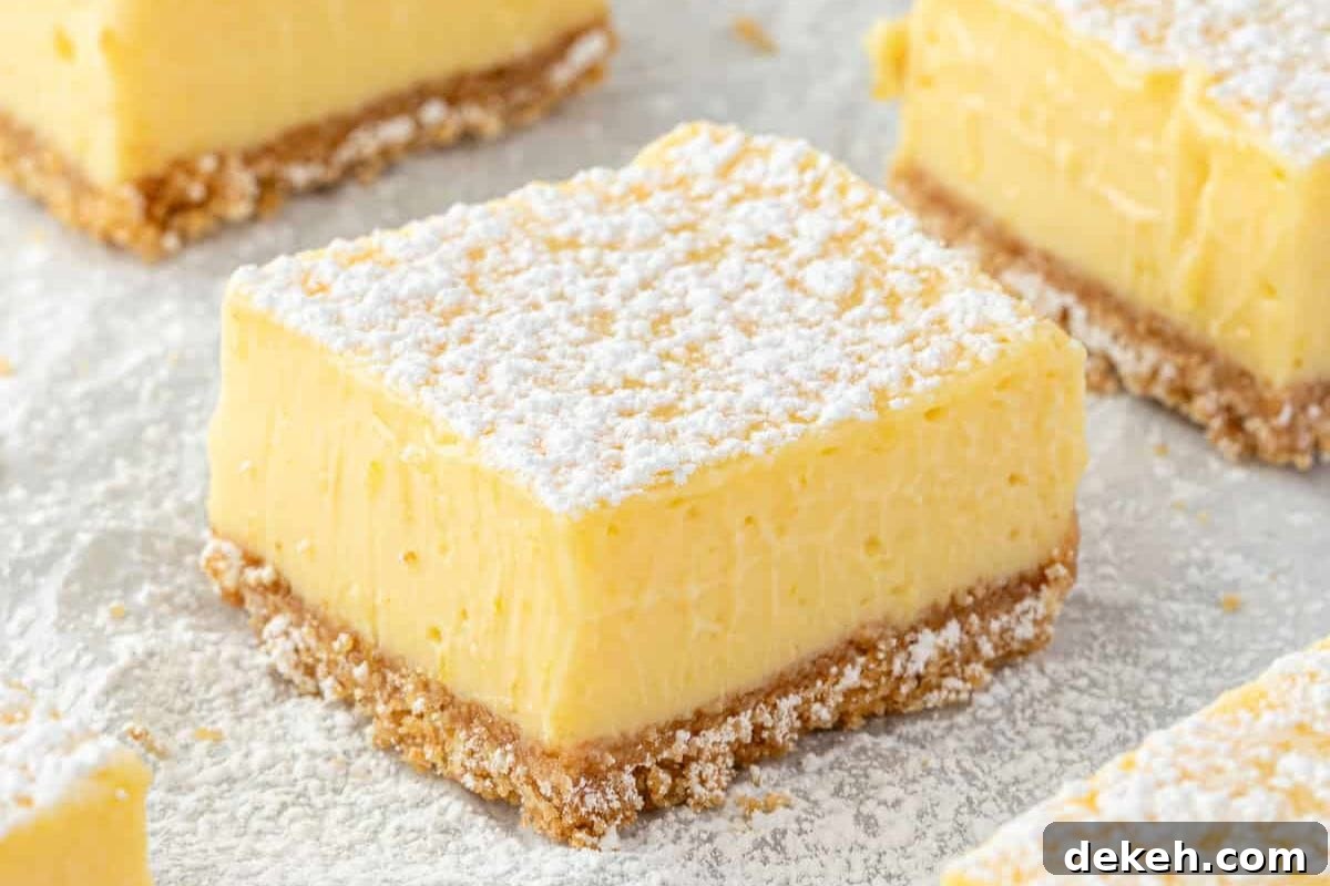 Delicious lemon bars dusted with powdered sugar, featuring a creamy lemon filling atop a crumbly shortbread crust.