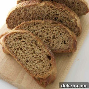 Several slices of rye bread on a cutting board.