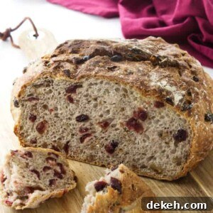 Close up view of a cut loaf of bread and two broken chunks