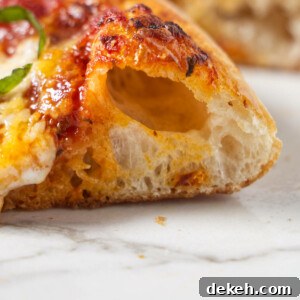 A closeup of the crust on a freshly baked pizza.
