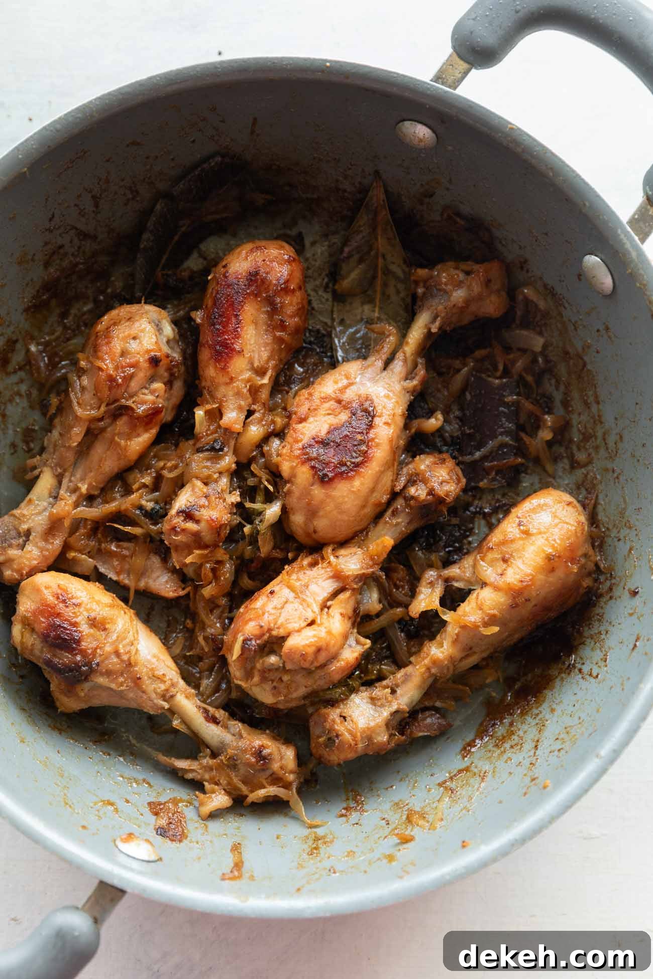 Picture of onion chicken in a grey pan